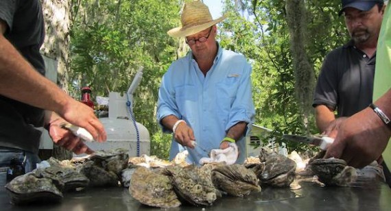 Andrew Zimmern of Bizarre Foods America shucks Louisiana oysters at a backyard crawfish boil in Bayou Pigeon. Photo courtesy of the Travel Channel.