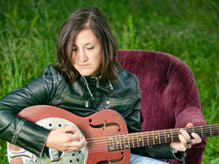 Kelcy_Mae_chair_grass_guitar_ReverbNation