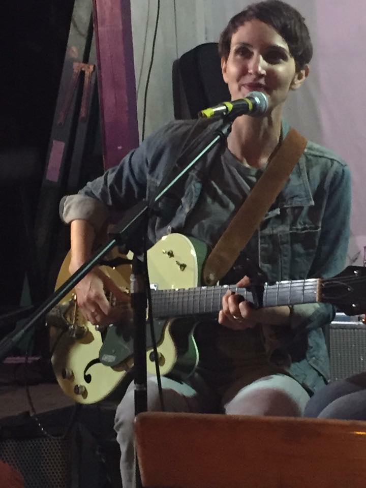Scott with her green Gretsch guitar.