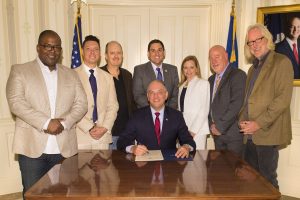 BATON ROUGE, LA - JULY 17: (L-R) Recording Academy members Sean Ardoin, Tim Kappel, Jay Weigel, Governor John Bel Edwards, Louisiana State Representative Walt Leger, Senior Analyst Kim Dodd, Reid Wick and Ken Shepherd gather at the Governor's Mansion for a ceremonial signing of House Bill No. 646 on July 17, 2017 in Baton Rouge, Louisiana. (Photo by Erika Goldring/Getty Images for The Recording Academy)